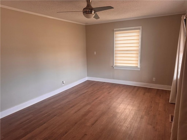 spare room featuring ceiling fan, dark wood-type flooring, ornamental molding, and a textured ceiling