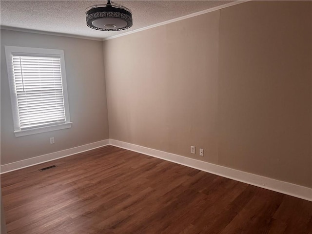 unfurnished room with ornamental molding, dark hardwood / wood-style flooring, and a textured ceiling