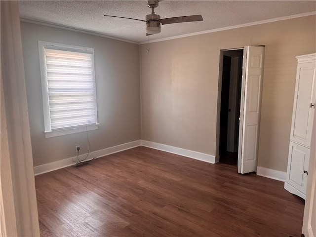 empty room featuring crown molding, ceiling fan, dark hardwood / wood-style flooring, and a textured ceiling