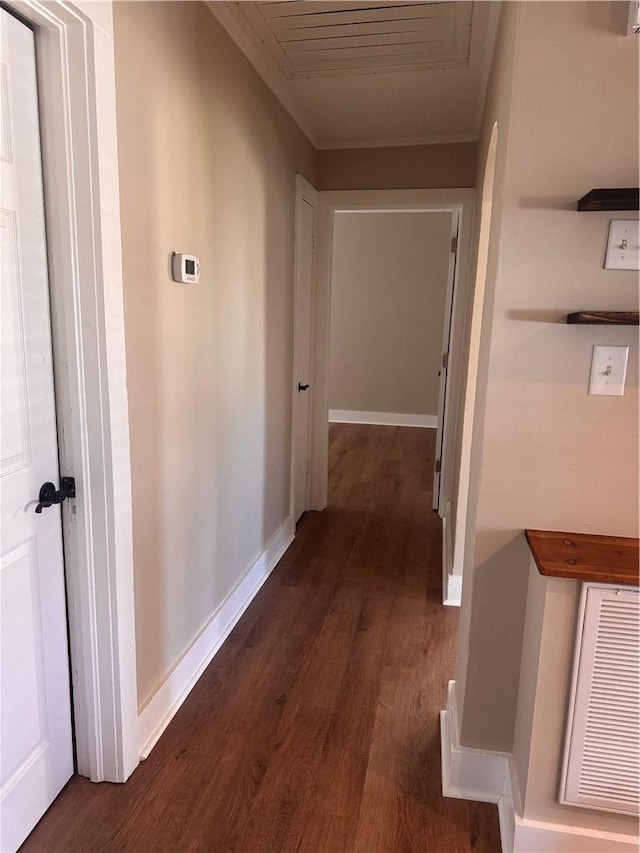 corridor with dark hardwood / wood-style flooring