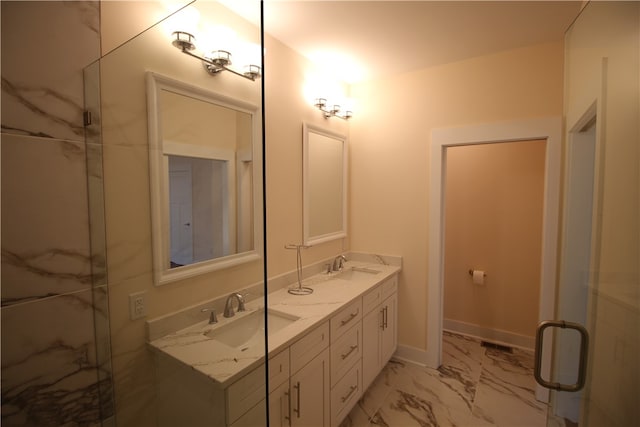 bathroom featuring vanity and a shower with door