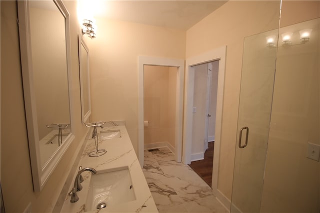 bathroom featuring vanity and a shower with shower door