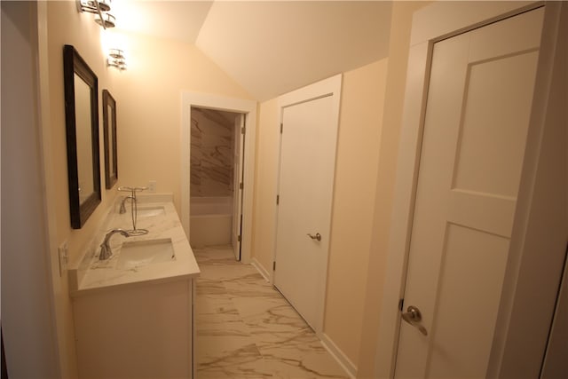 bathroom with vanity and lofted ceiling