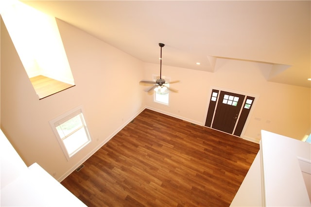 foyer entrance featuring vaulted ceiling, ceiling fan, and dark wood-type flooring