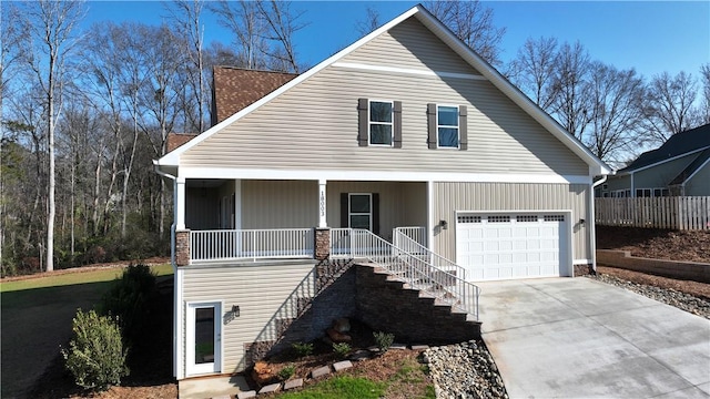 view of front of property featuring covered porch and a garage