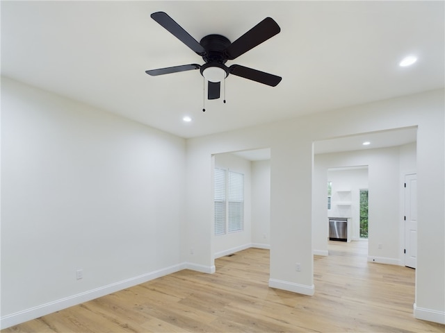 spare room with ceiling fan and light hardwood / wood-style flooring