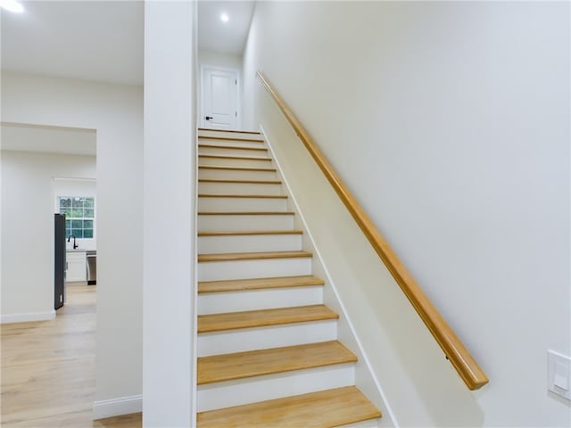 stairway featuring hardwood / wood-style floors