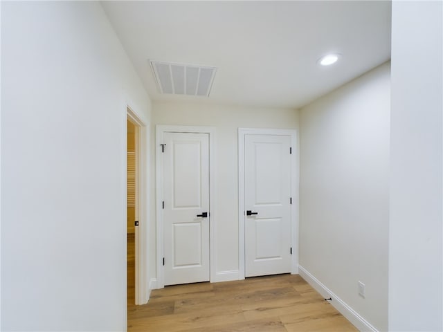 hallway with light hardwood / wood-style flooring