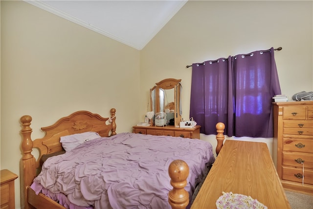 bedroom featuring carpet, vaulted ceiling, and crown molding