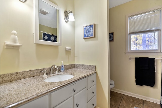 bathroom featuring tile patterned floors, vanity, and toilet