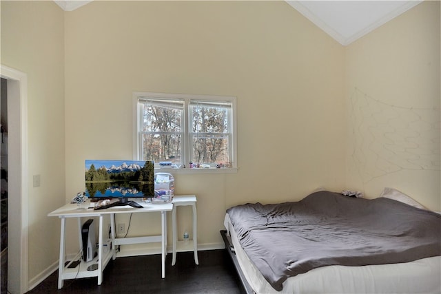 bedroom with crown molding, dark wood-type flooring, and vaulted ceiling