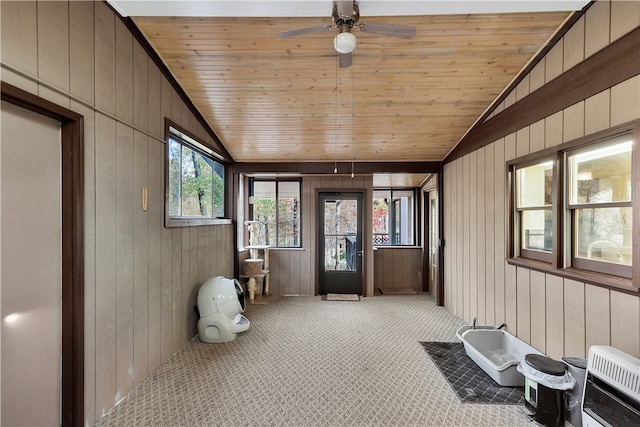 sunroom / solarium with heating unit, ceiling fan, wood ceiling, and vaulted ceiling