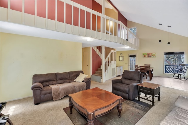 living room featuring carpet and high vaulted ceiling