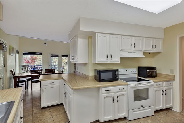 kitchen featuring premium range hood, white cabinets, white electric range oven, and light tile patterned floors