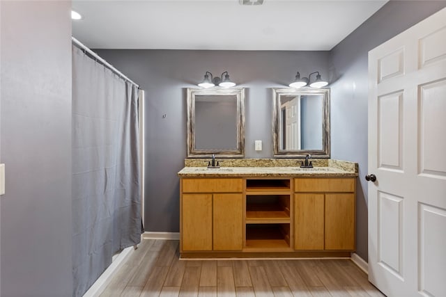 bathroom with vanity, a shower with shower curtain, and hardwood / wood-style flooring