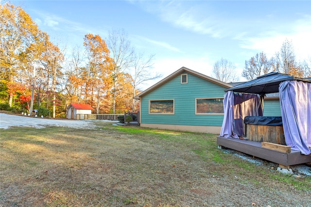 view of home's exterior with a gazebo, a shed, and a yard