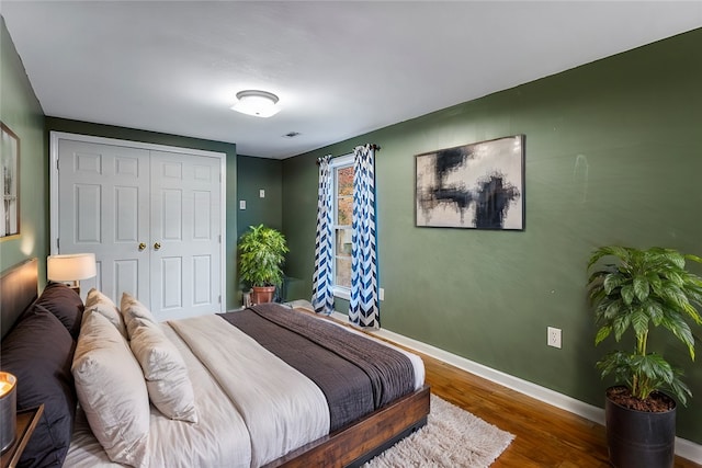 bedroom with a closet and hardwood / wood-style flooring