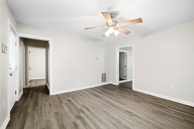 spare room with ceiling fan and dark wood-type flooring