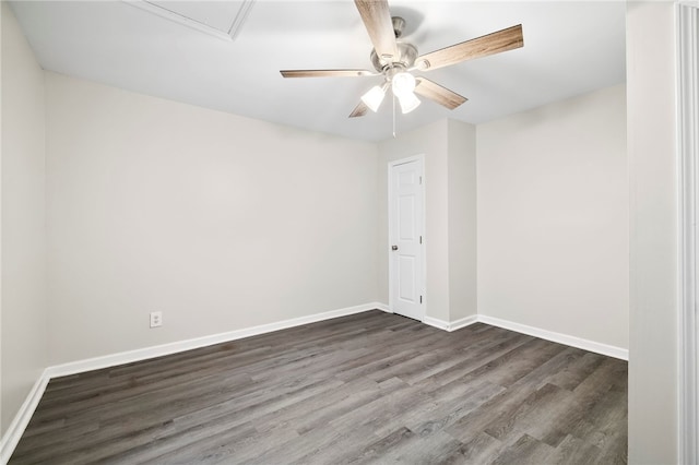 spare room with dark hardwood / wood-style flooring and ceiling fan