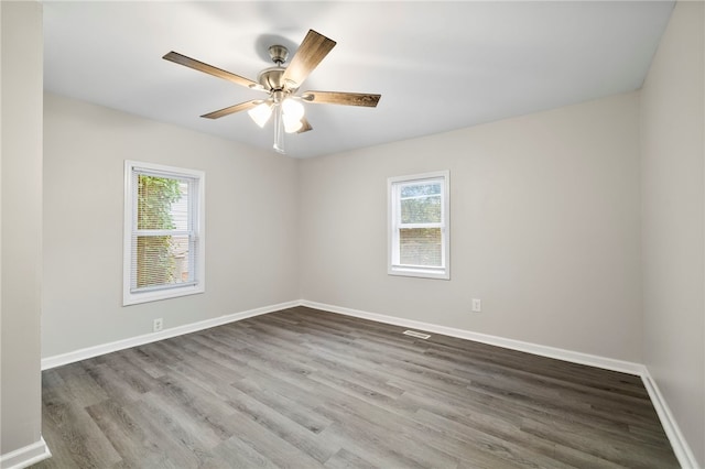 unfurnished room with ceiling fan, hardwood / wood-style floors, and a healthy amount of sunlight