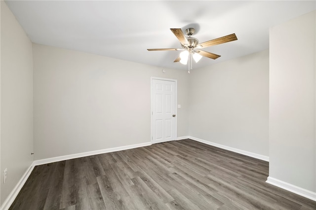 unfurnished room with dark hardwood / wood-style floors and ceiling fan