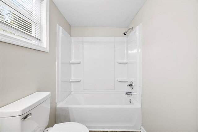 bathroom featuring bathing tub / shower combination and toilet