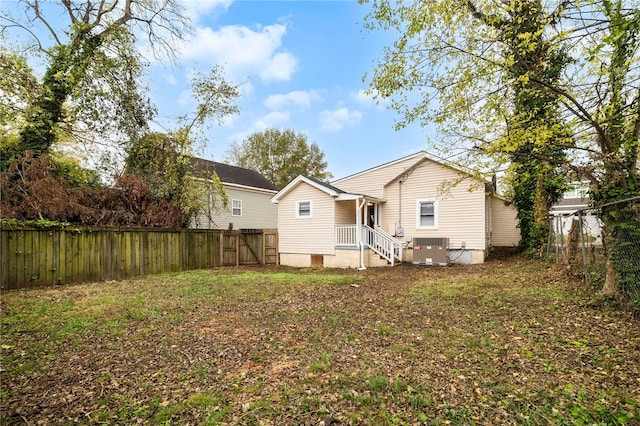 back of house with central AC unit