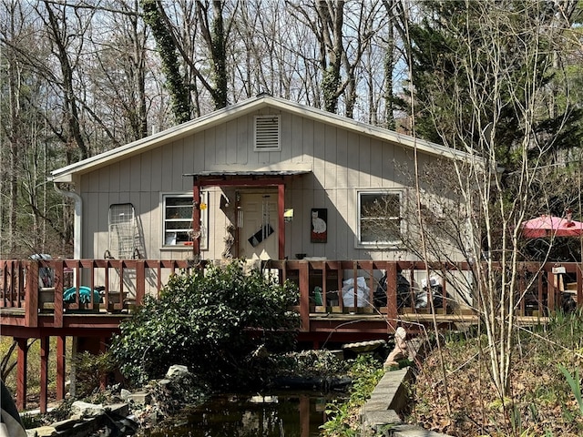 rear view of property featuring a deck