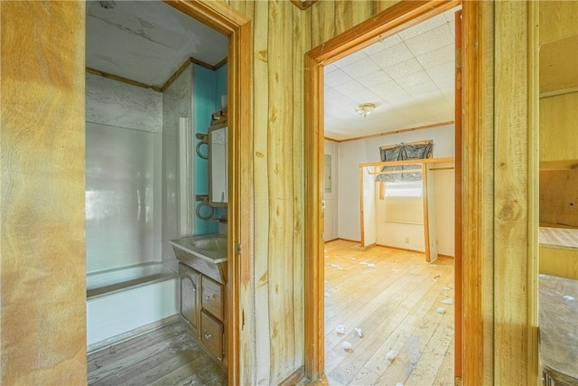 bathroom with wood-type flooring and crown molding