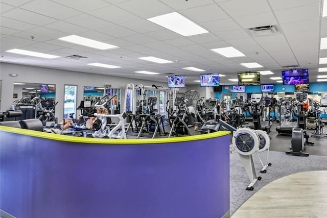 exercise room featuring a drop ceiling