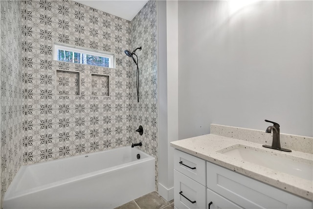 bathroom featuring tile patterned floors, vanity, and tiled shower / bath combo