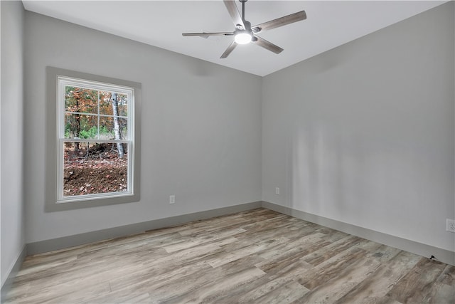 spare room featuring light hardwood / wood-style floors and ceiling fan