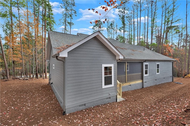 view of property exterior with a sunroom