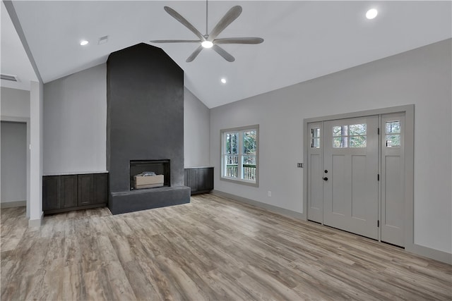 unfurnished living room with a fireplace, high vaulted ceiling, light hardwood / wood-style flooring, and ceiling fan