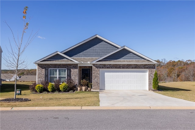 view of front of property with a front yard and a garage