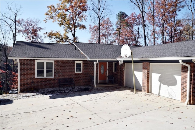 ranch-style home with an attached garage, brick siding, and driveway