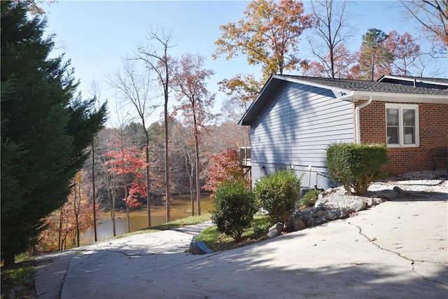 view of property exterior featuring brick siding
