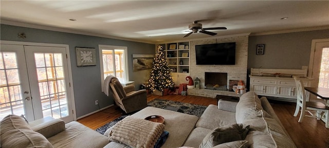 living room with ornamental molding, a ceiling fan, french doors, and wood finished floors