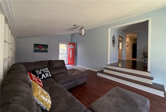 living room featuring a notable chandelier, dark hardwood / wood-style flooring, and lofted ceiling