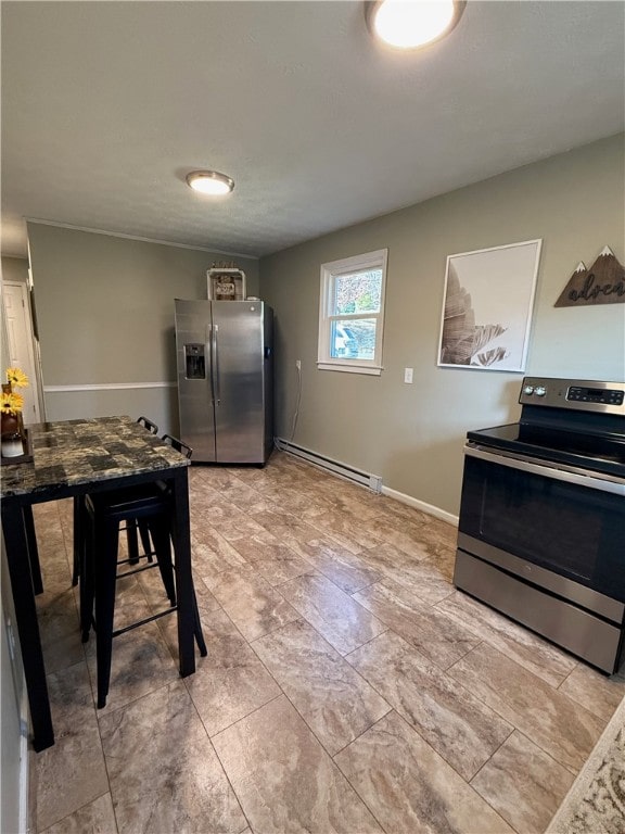 kitchen featuring baseboard heating and appliances with stainless steel finishes