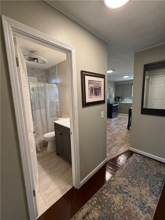 hall featuring ornamental molding and dark wood-type flooring