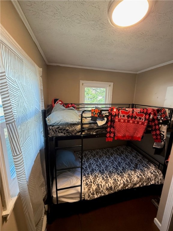 bedroom with crown molding and a textured ceiling