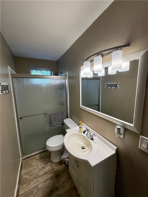 bathroom with toilet, vanity, and walk in shower