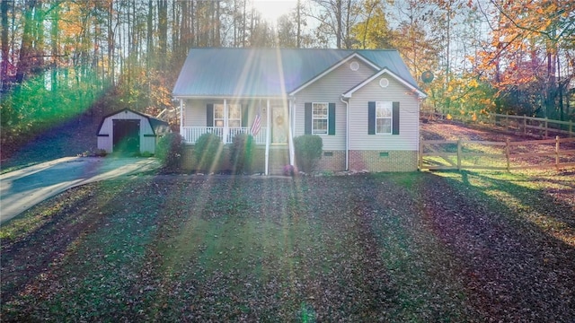 view of front facade with a storage shed and covered porch