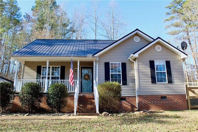 view of front of home featuring a porch, crawl space, and metal roof