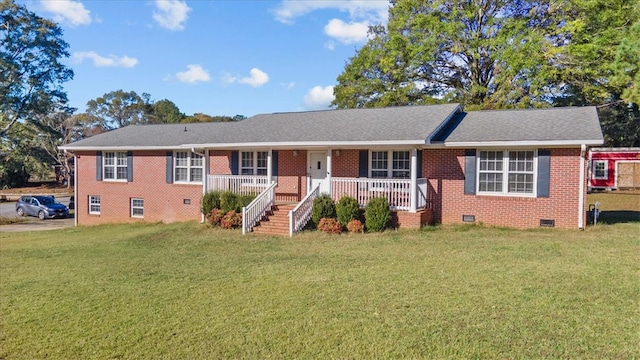 ranch-style home with covered porch and a front yard