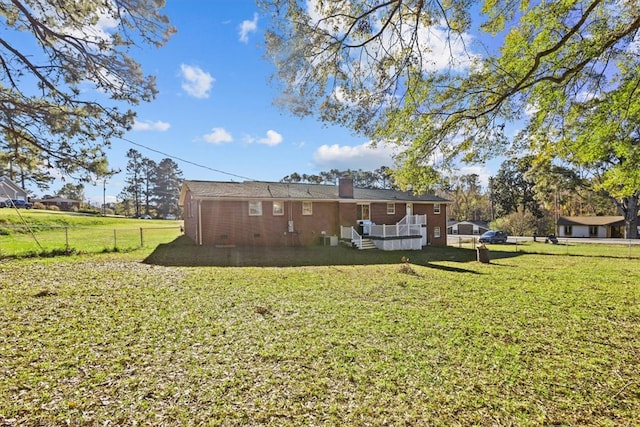 rear view of property featuring a yard