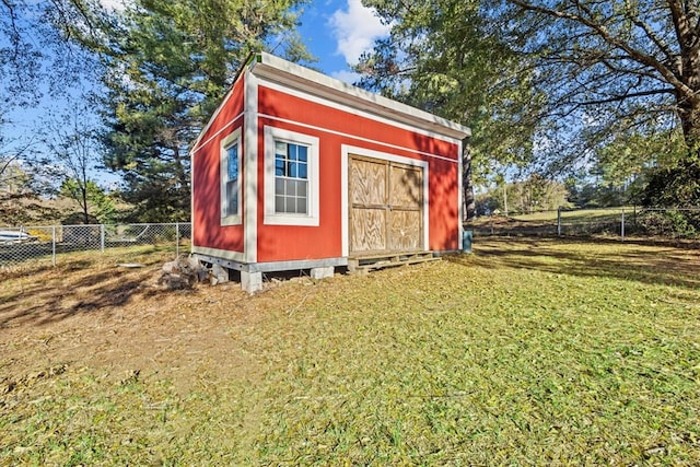 view of outbuilding with a yard