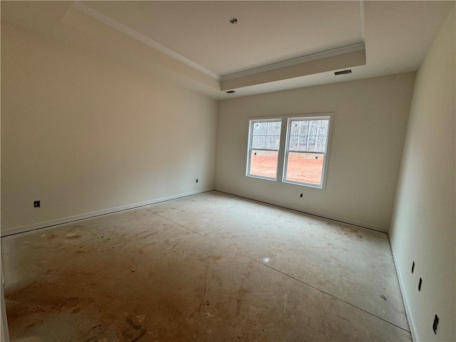 unfurnished room with ornamental molding, a tray ceiling, and visible vents