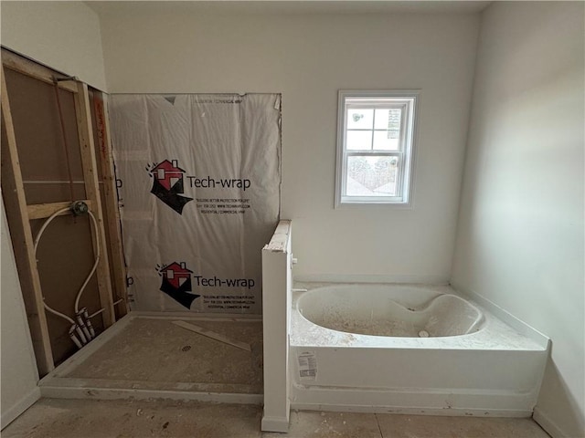 bathroom featuring a garden tub and a walk in shower